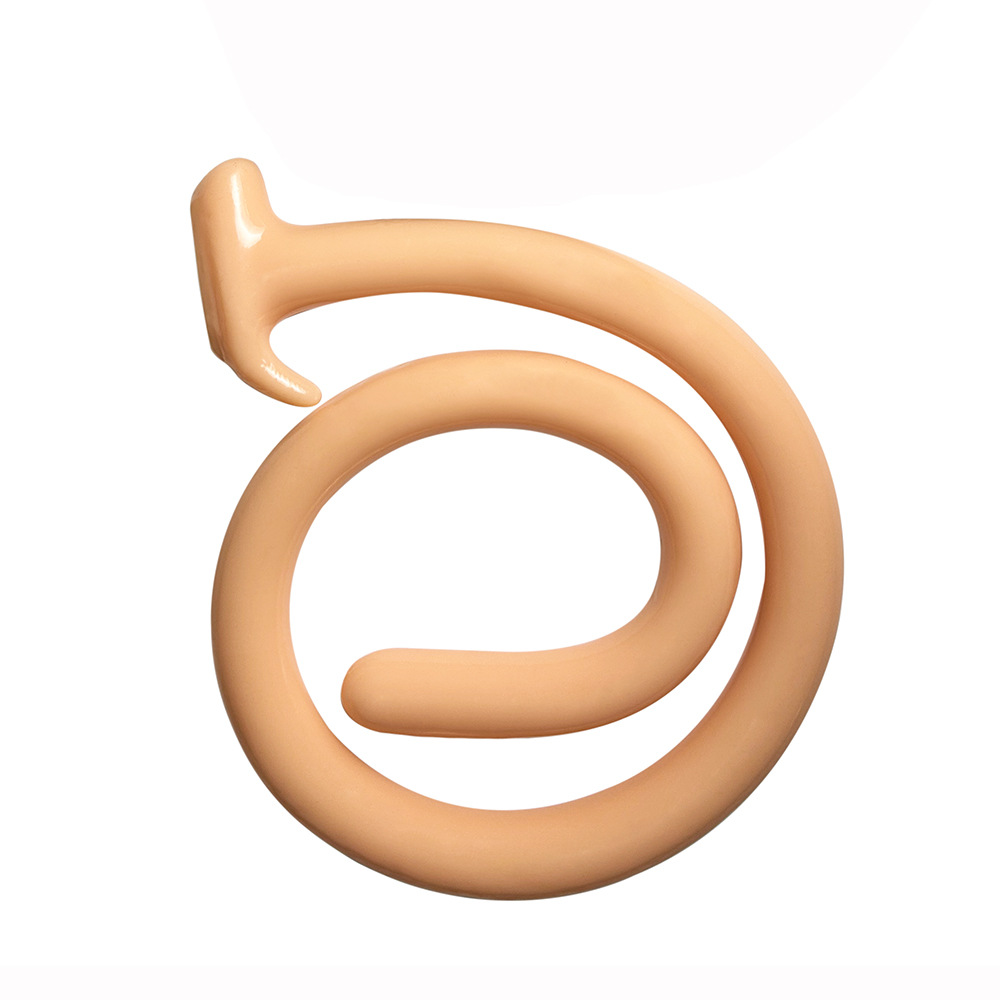 Coiled flesh-colored dragon tail plug mimicking the smooth texture of a full silicone butt.