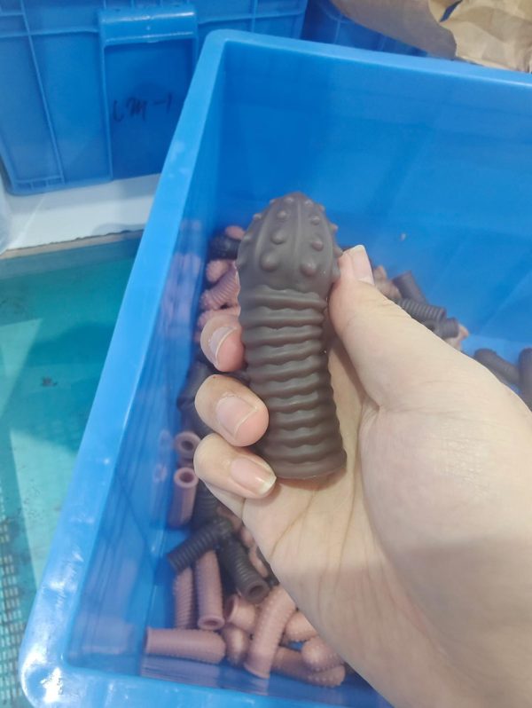 Dark colored ribbed and textured silicone cock sleeve for enhanced stimulation