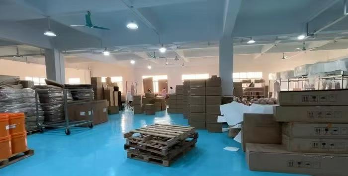 Internal view of the spacious Dongguan Xishang warehouse organized with bulk stock for international distribution.