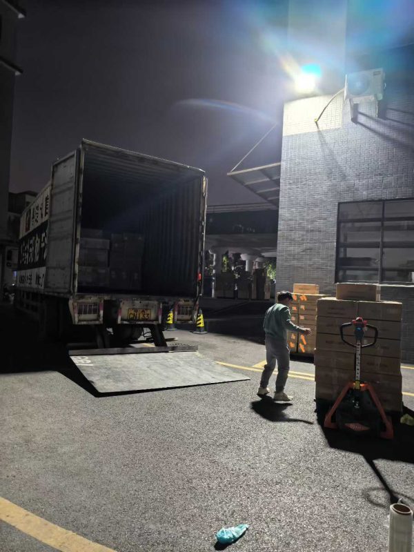 Logistics team loading a truck at night outside the Dongguan Xishang facility for timely global fulfillment.