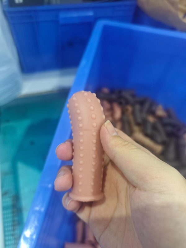 Pink studded silicone penis extender sleeve with stimulating dots texture