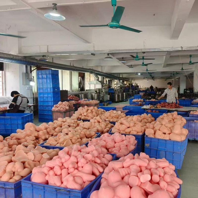 PleasureMo high quality silicone sex doll factory workshop with large quantity of doll torsos in blue storage bins