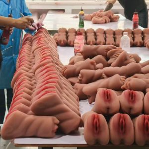 PleasureMo skilled workers performing detailed painting and quality inspection on silicone sex doll parts
