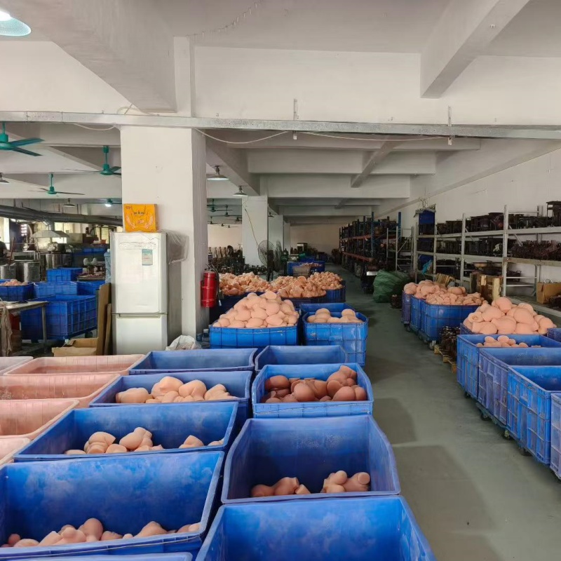 PleasureMo adult toy factory warehouse aisle with organized blue crates full of silicone products