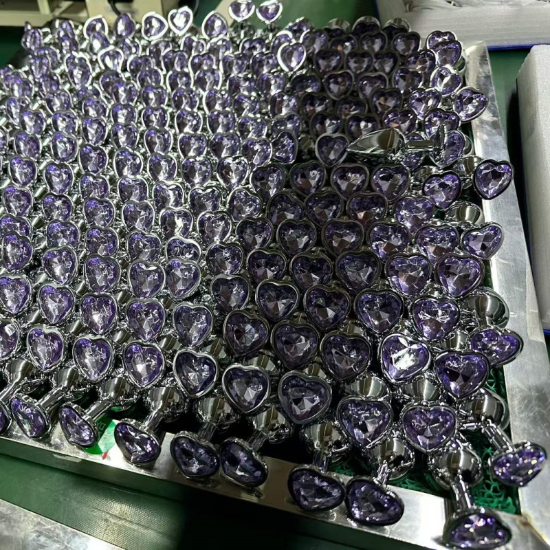 Bulk purple amethyst heart shaped jeweled glass anal plugs with shiny metal bases at PleasureMo factory