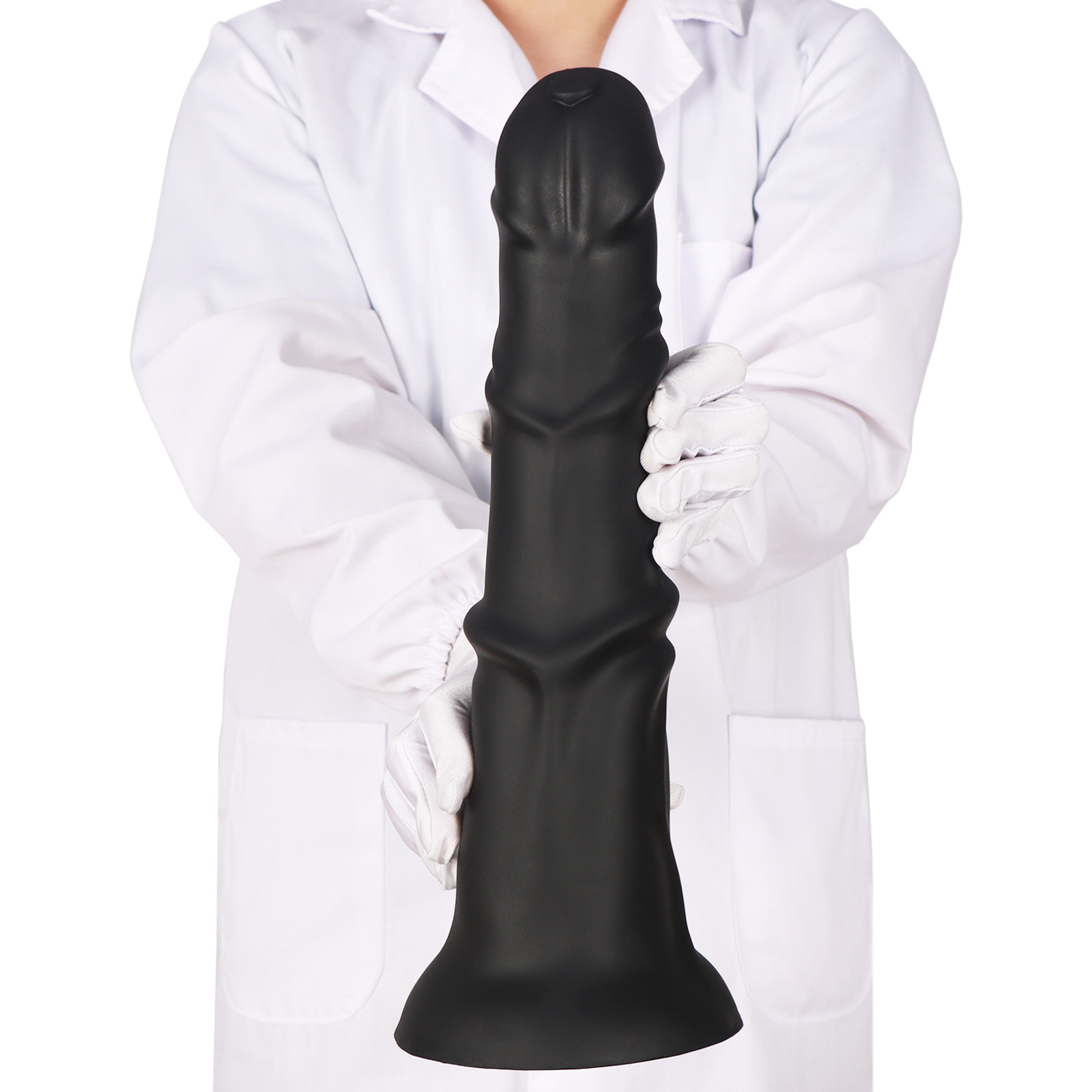 Person in white coat holding large horse dildo to show massive size