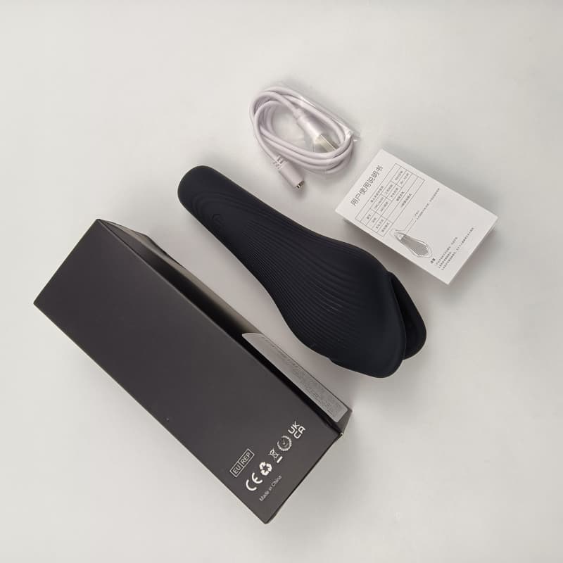 Complete package of the whale penis trainer with box, manual, and charging cable