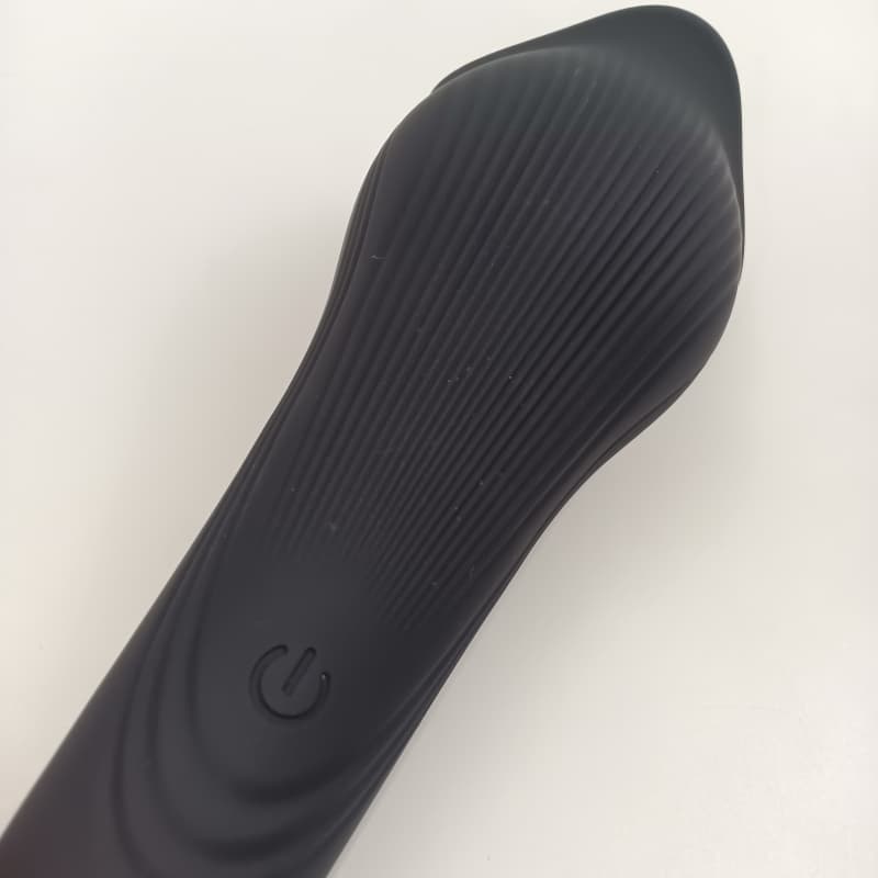 Power button and textured silicone handle design on the whale penis trainer